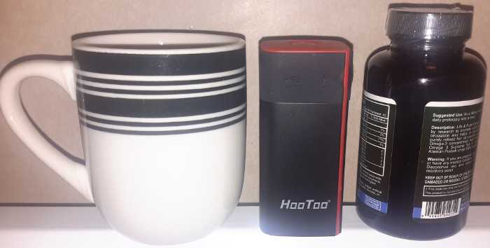The TripMate SITH size compared to a mug and vitamin bottle.
