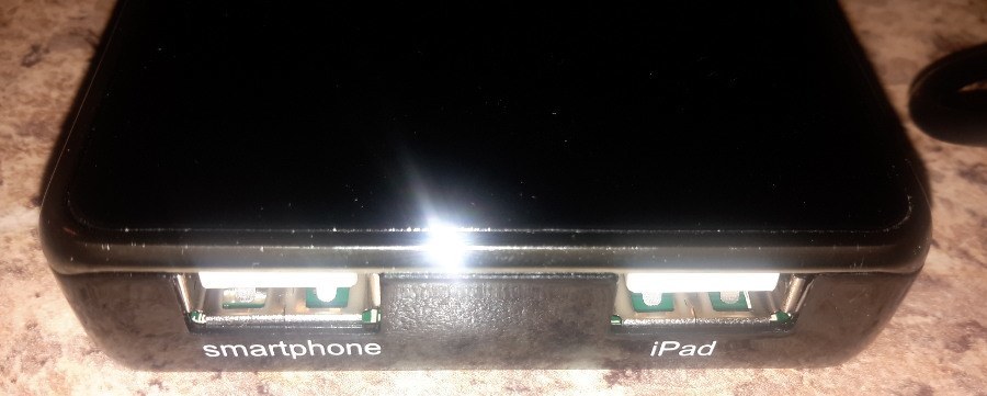 Two labeled ports on power bank: smartphone and iPad.