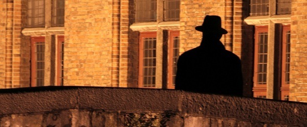 Man On A Bridge In Brugge, Belgium.