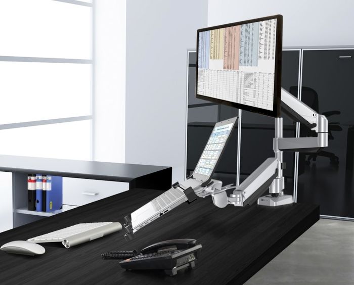 Loctek Dual Arm Desk Mount monitor high and laptop low.