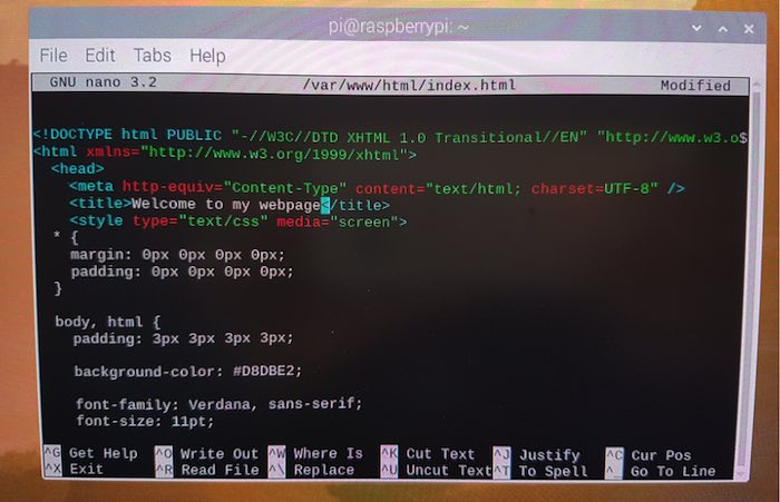 You can edit the default HTML page in Raspbian's Nano text editor.