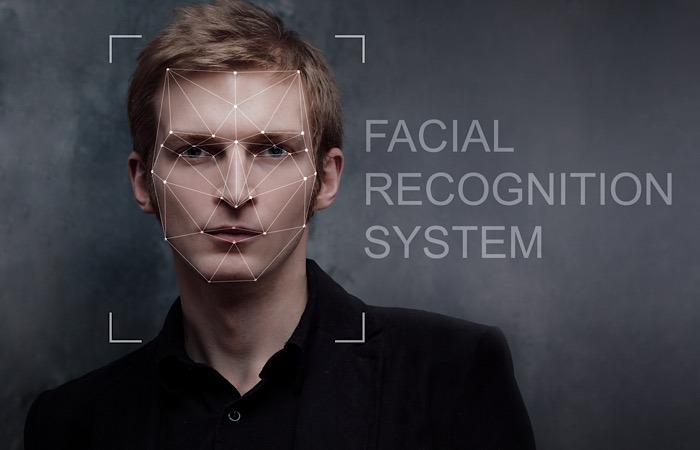 Young Man In Jacket Thoughtfully Looks Into The Camera