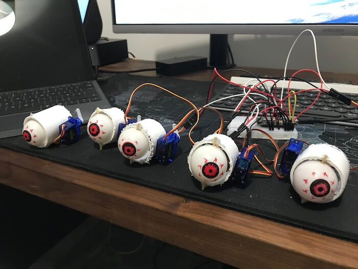 You'll need to use one servo for each Halloween eyeball.