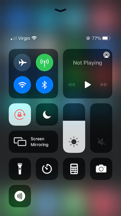 You can activate Dark Mode in iOS' Control Center.