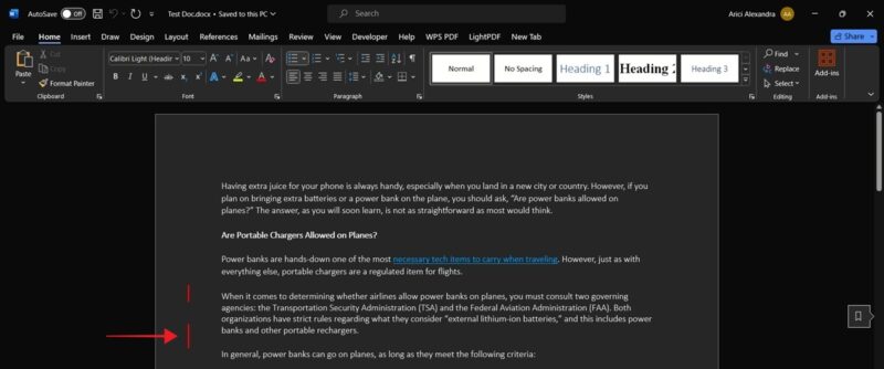 Clicking vertical red line to show revisions in Word document on desktop.
