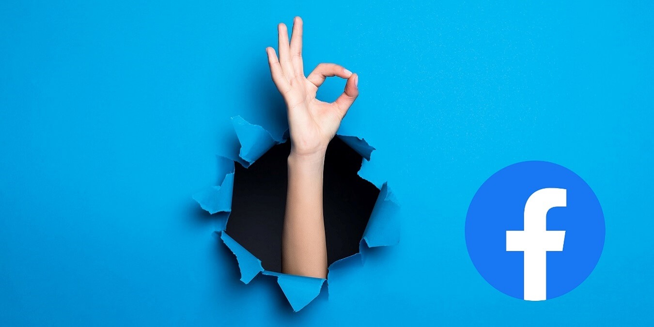 Close Up Woman Hand With Okay Gesture Through Blue Hole Paper Wall