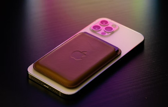 Apple phone with a physical wallet on the back.