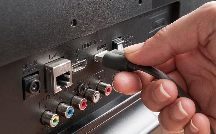 Removing and reinserting the HDMI cable from its port on a TV.
