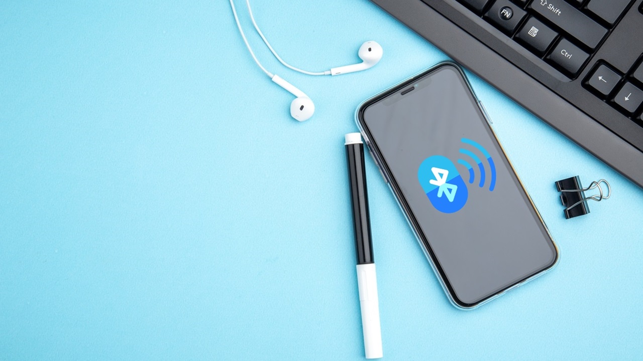 Top View Of Office Concept With Mobile Phone Headphone On Blue Background