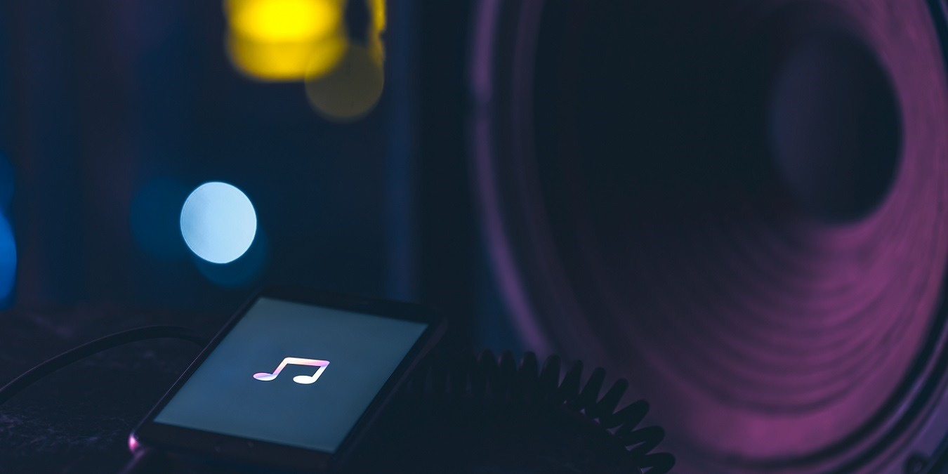 Phone With Music Listening Icon On Screen On Dark Background, Copy Space.