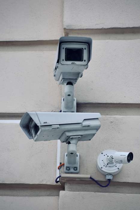 Three Outdoor Cameras Mounted On Wall
