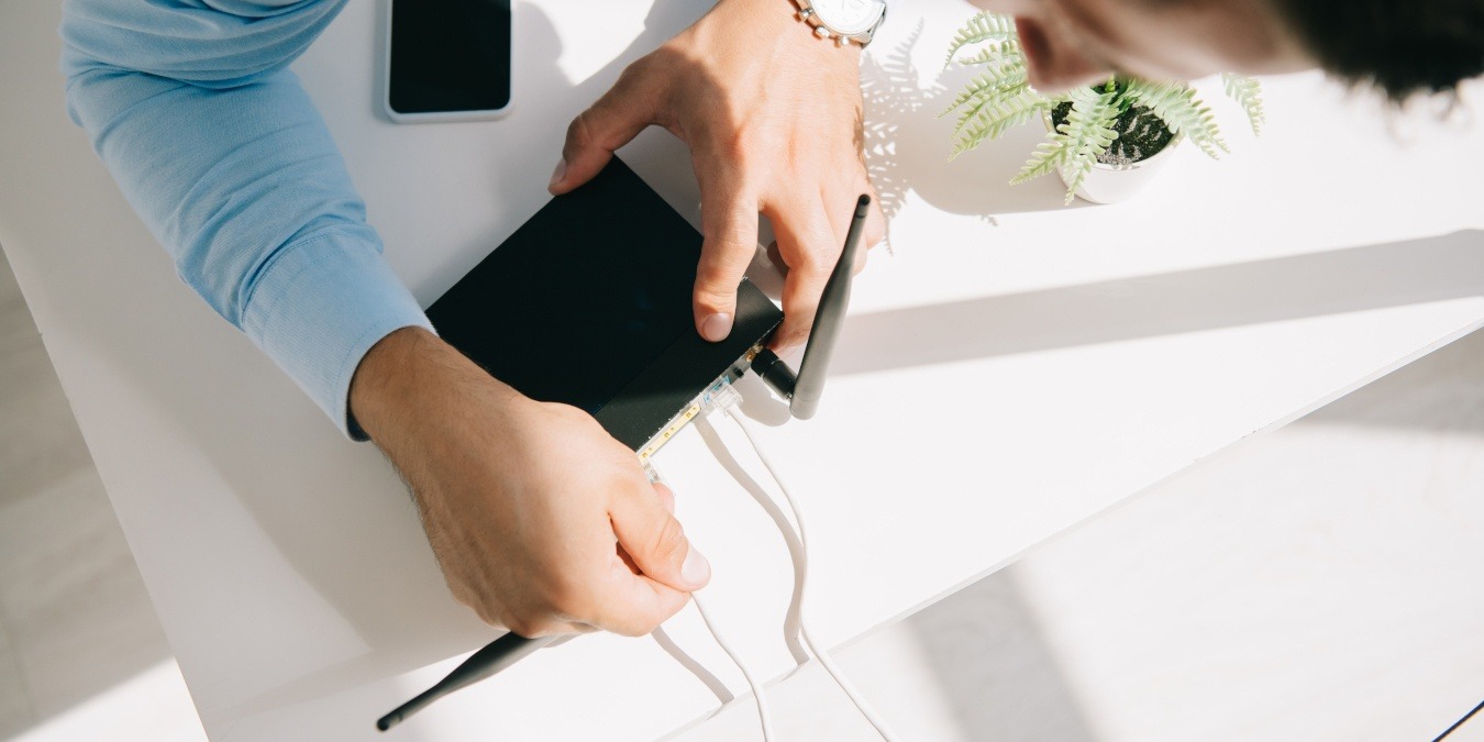 Man Setting Up Mesh Wireless Networking Kit