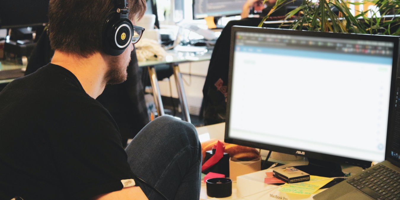 A peron in front of a computer typing.