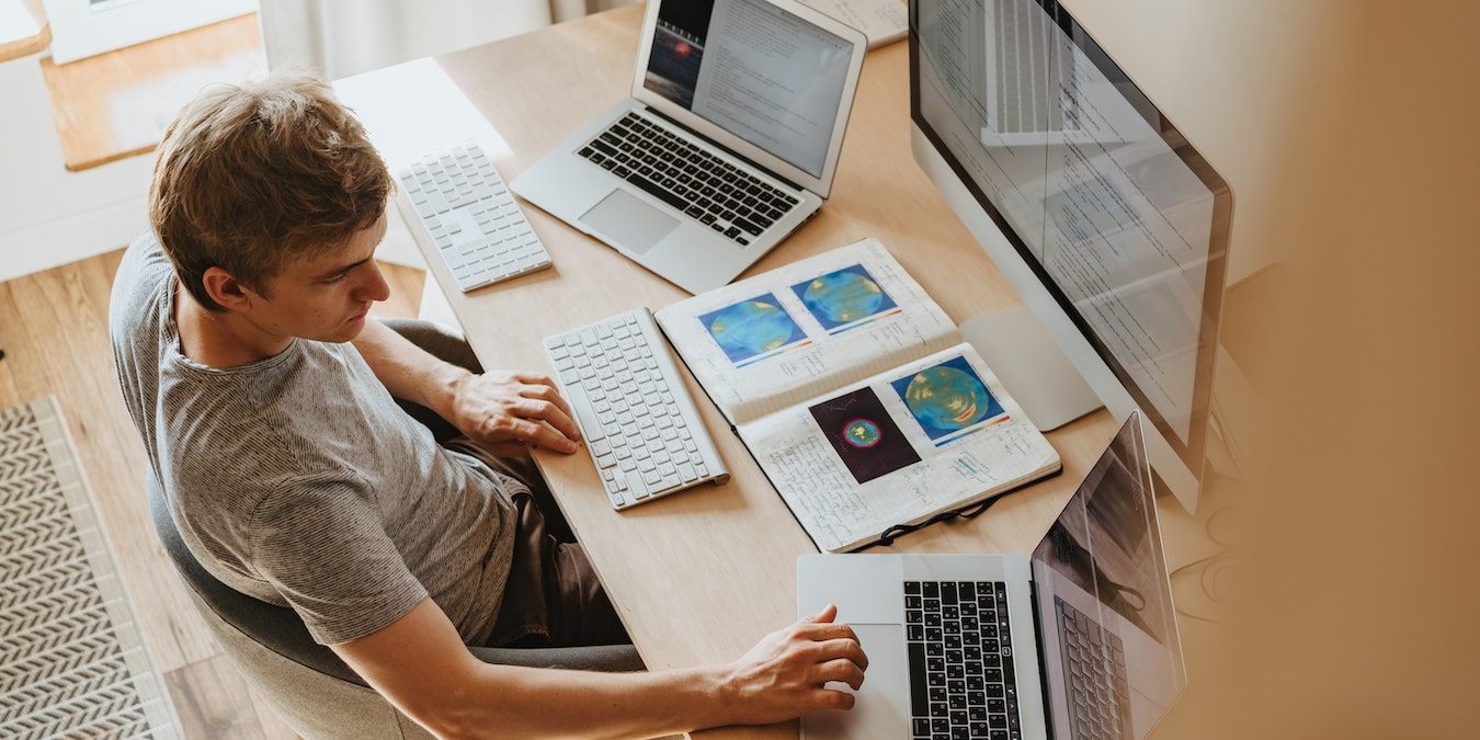 Man Working With Three Computers