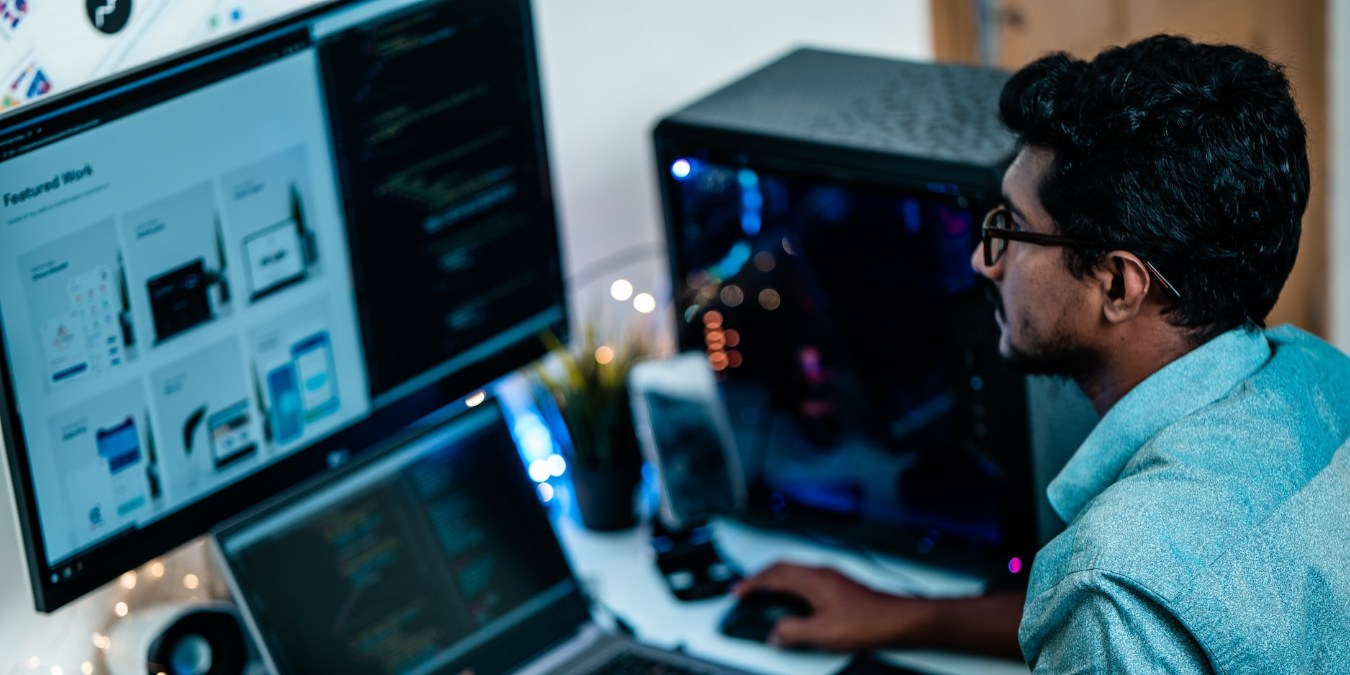 Man in blue shirt using computer