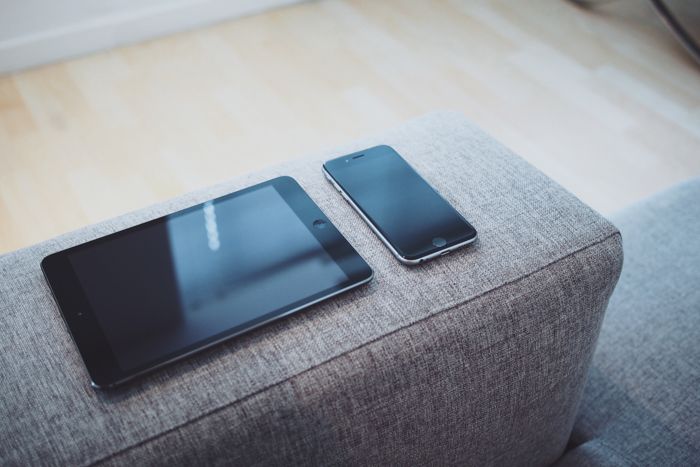 Phone And Tablet On Sofa Stock Image