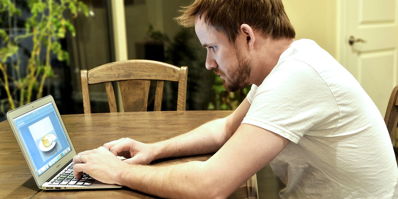 Adult working on a laptop on a table