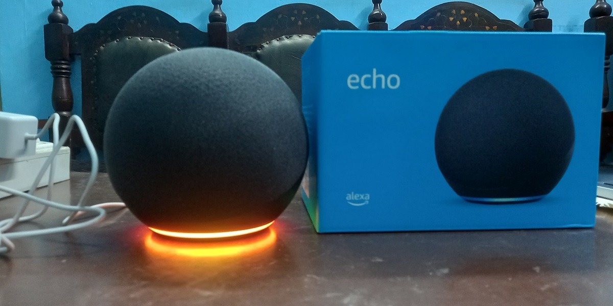 Alexa is in setup mode indicated by orange light at bottom. 