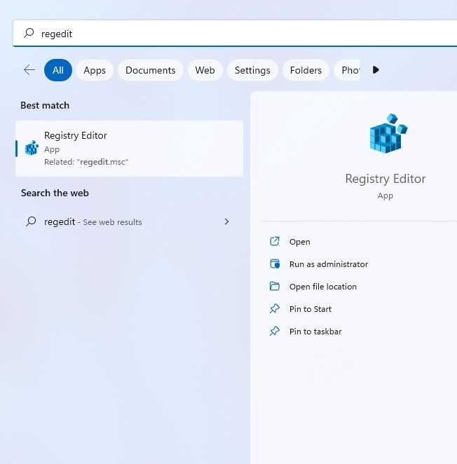 Typing "regedit" in Windows Search.