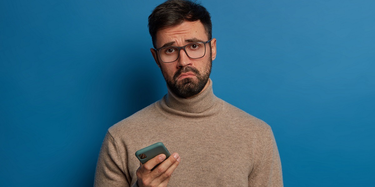 A sad person checking their phone