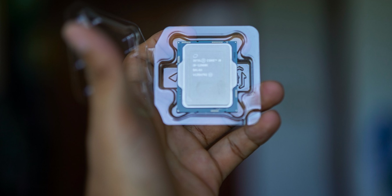 person holding Intel processor in their hand