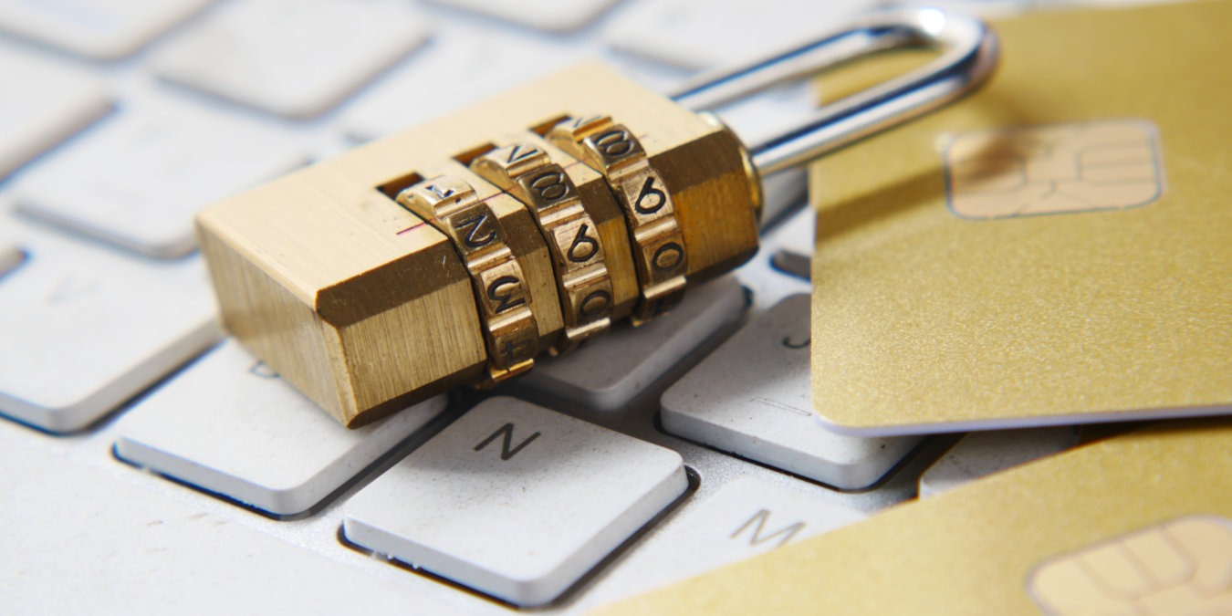 A photograph of a rotary padlock on top of a computer keyboard.