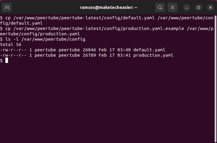 A terminal window showing both the default and production config files.