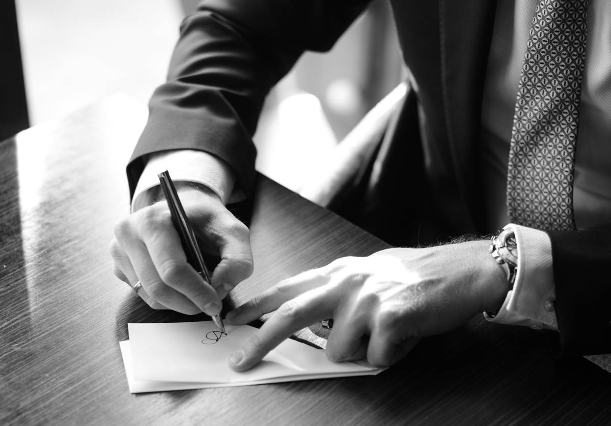 Man Signing On Paper Cropped Photograph By Signature Pro