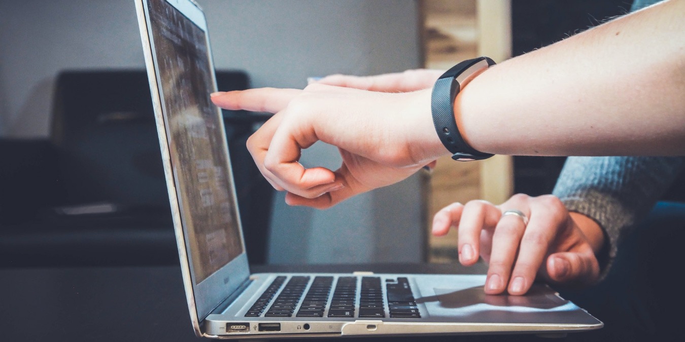 Hand pointed at a pc screen