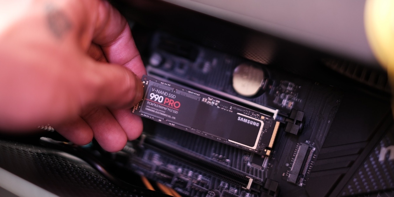 A person installing an NVMe SSD in a computer