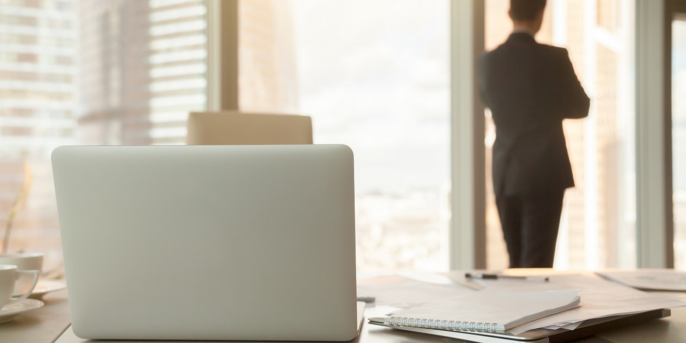 Office Workplace With Laptops And Documents, Male Silhouette At