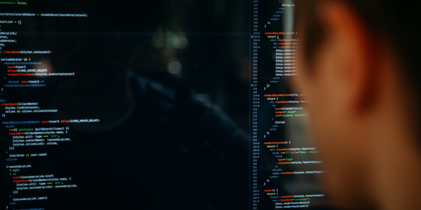 A photograph of a person editing code.