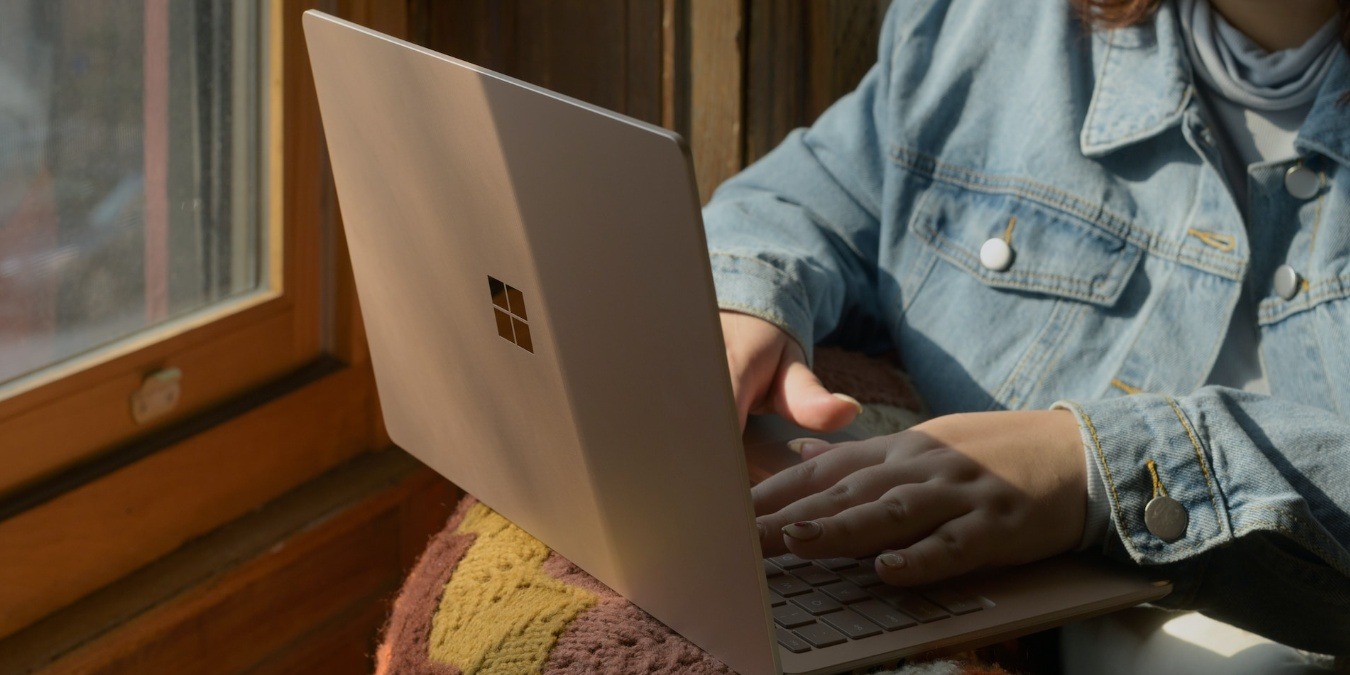 Person sitting in a chair using a Windows laptop