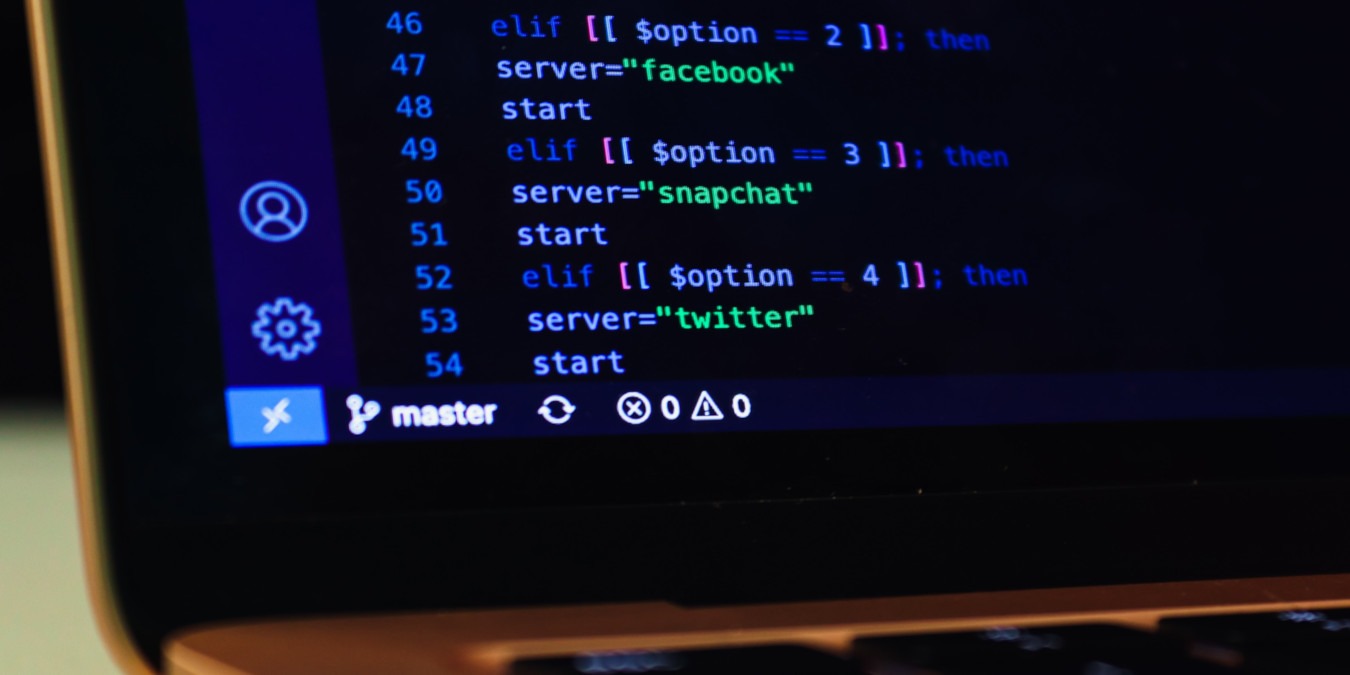A photograph of a laptop screen with a shell script in display.