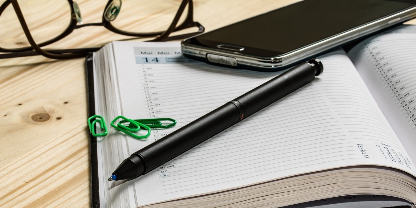 Calendar, agenda, pen, and phone