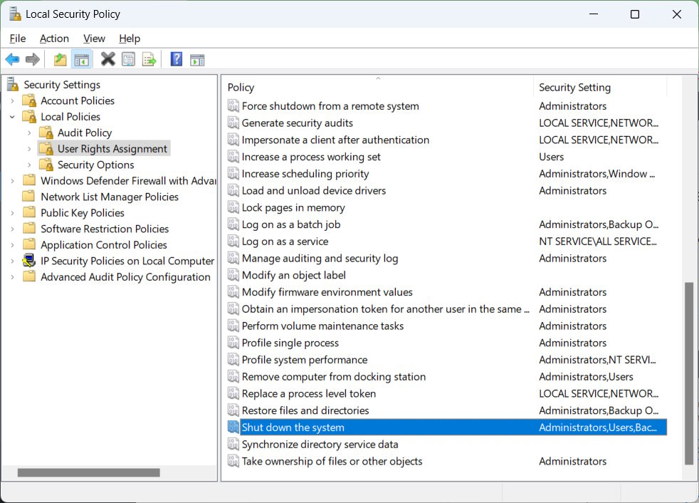 Navigating to "Shut down the system" policy under Local Security Policy.