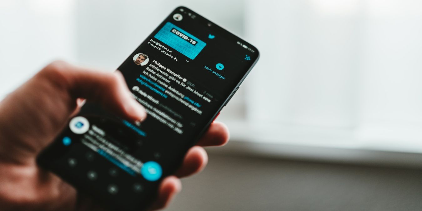 Person Using Twitter App On Smartphone