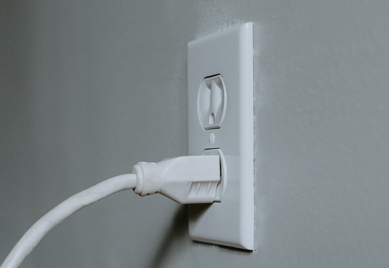 Computer cable connected to mains supply. 