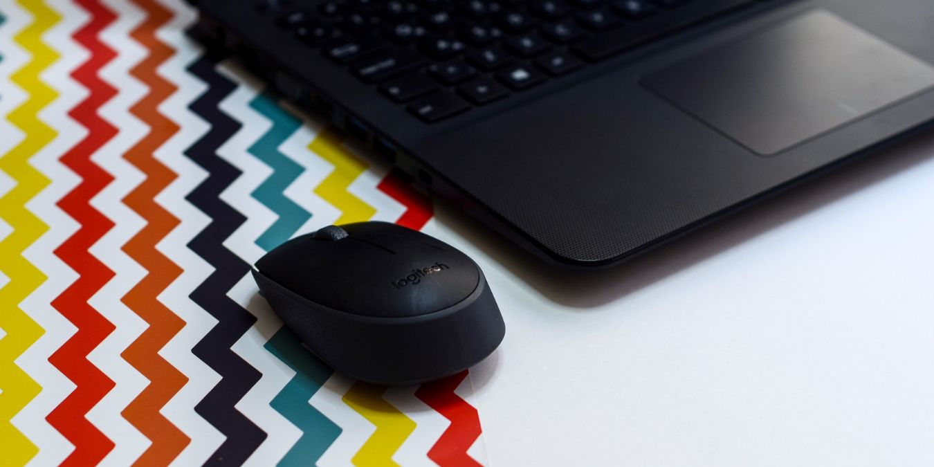 Wireless Mouse Beside A Laptop
