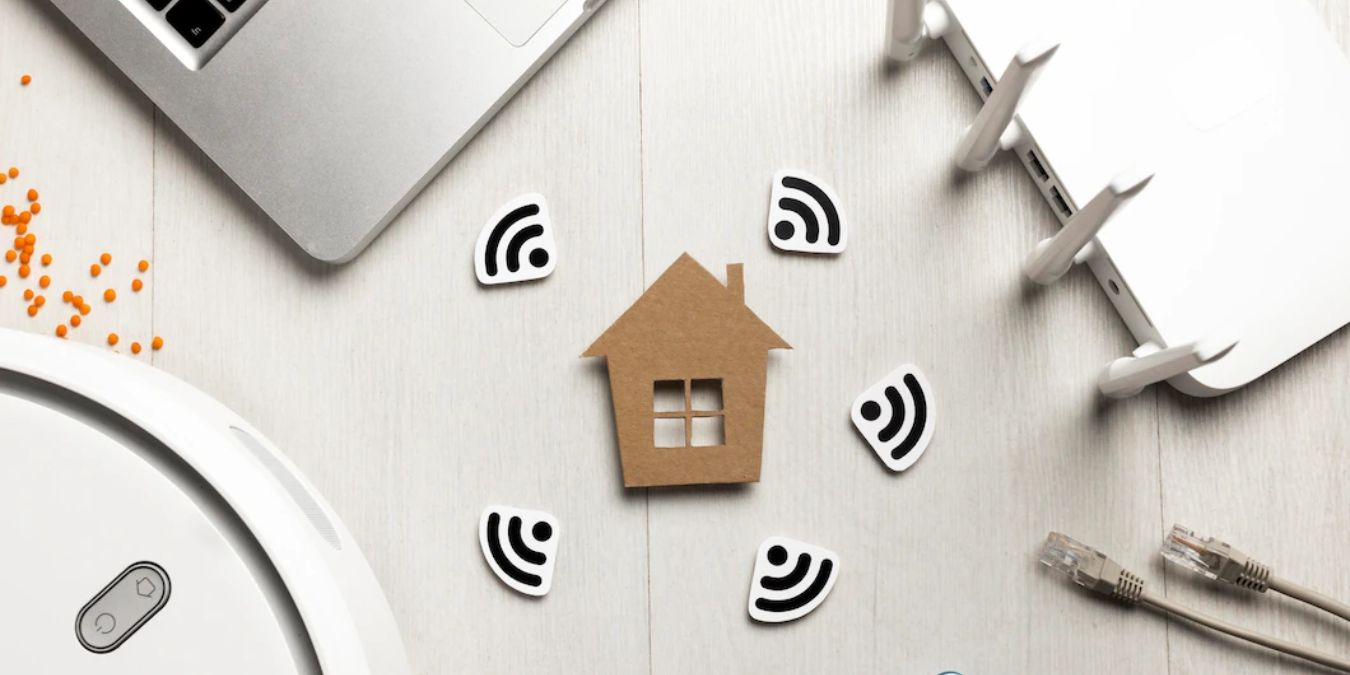 This photo shows a laptop, router, and LAN cable