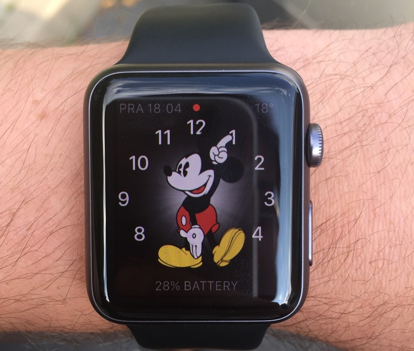 Apple Watch with a Mickey Mouse face and notification icon