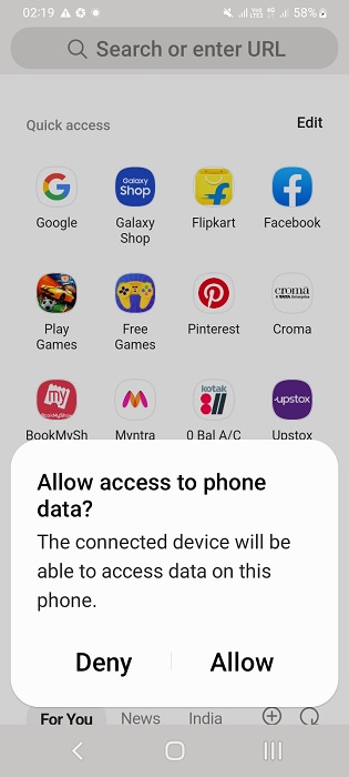 USB cable connected to laptop from phone, data access enabled.