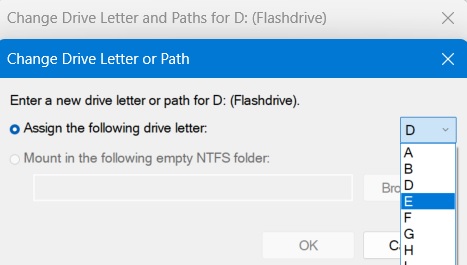 Selecting "E"' as drive letter for a USB drive and assigning it.