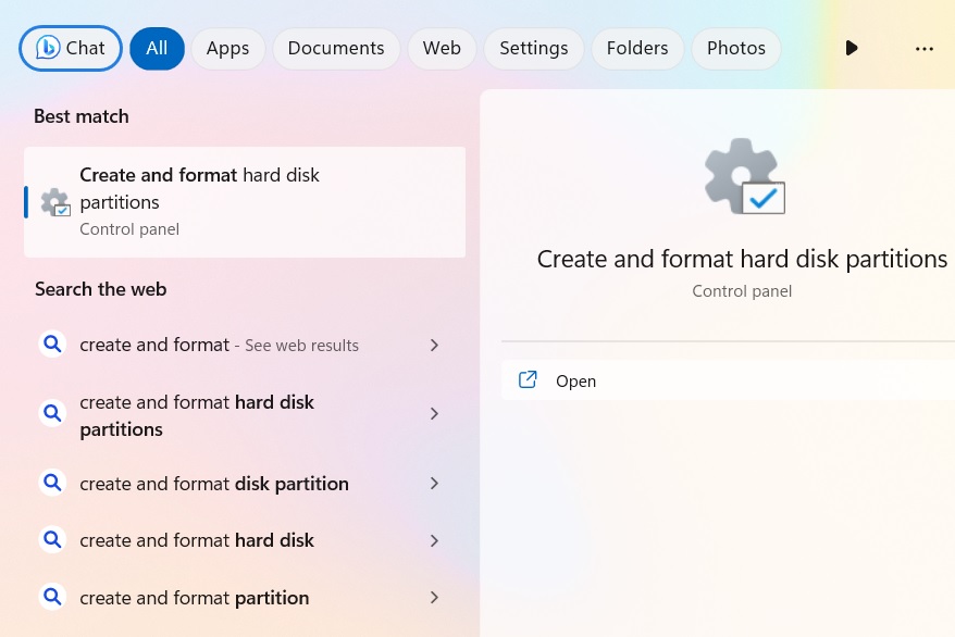 Accessing "Create and format hard disk partitions" from the Windows search box.