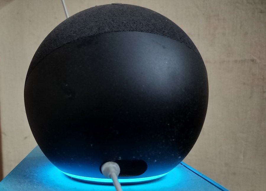 Alexa displaying slowly spinning teal on blue light, indicating startup or software update.