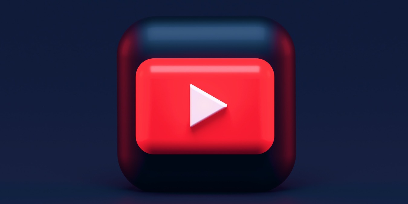 Stylized 3D YouTube logo on a dark background