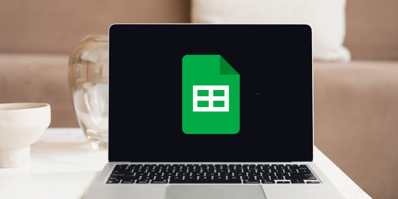 This photo shoes a laptop with the Google Sheets logo in dark mode