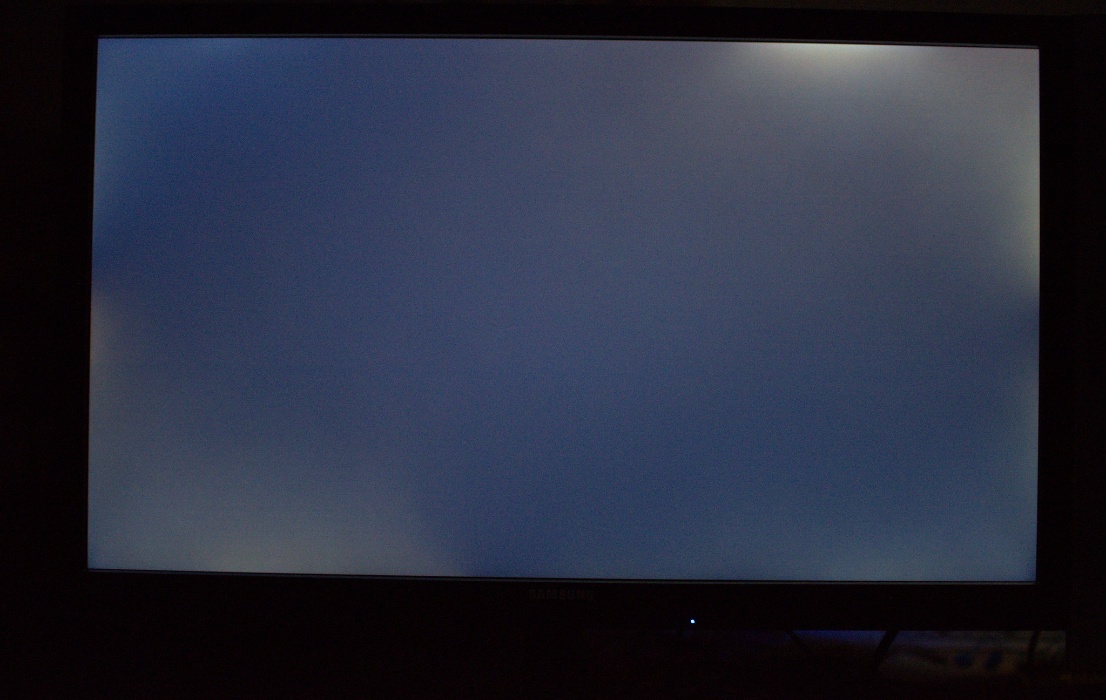 Large screen TV showing backlight bleeding effect in dark room