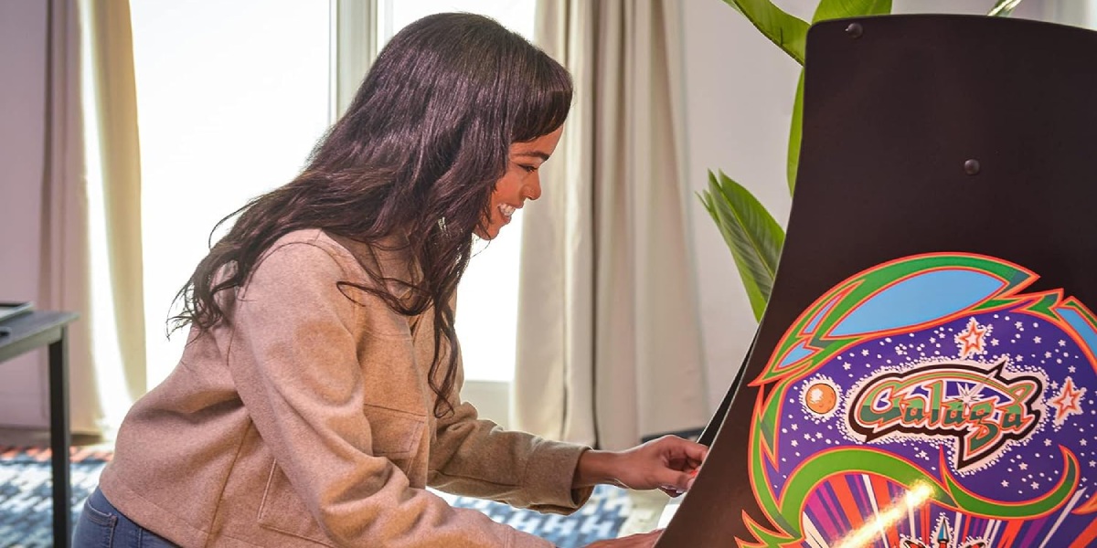 Woman Playing at Arcade Cabinets