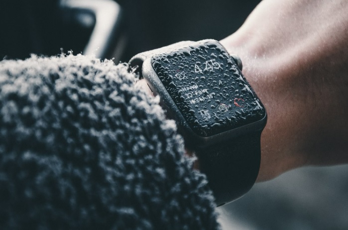 Apple Watch covered in rain drops.